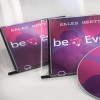 Изображение показывает два футляра для компакт-дисков с заголовком «Sales Meeting» и диск с красочным дизайном. Дизайн включает круги в оттенках розового и фиолетового, а также текст «beEven».